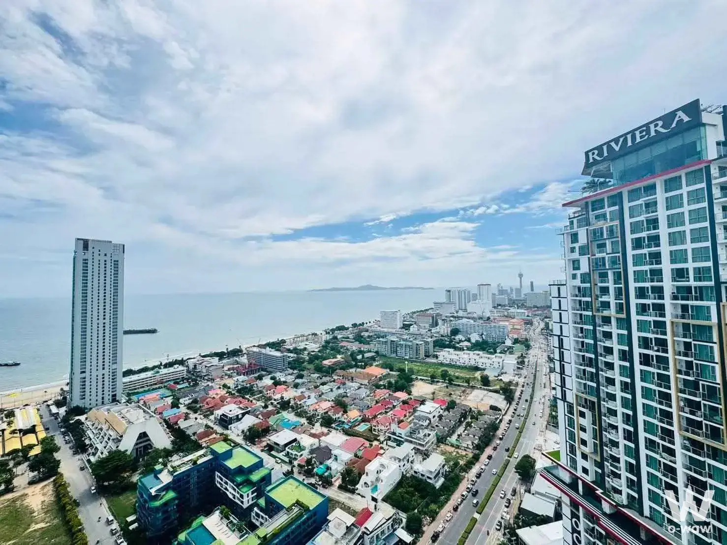 High-floor city view from Dusit Grand Condo View 1-bed condo for sale showing Riviera tower and coastal skyline