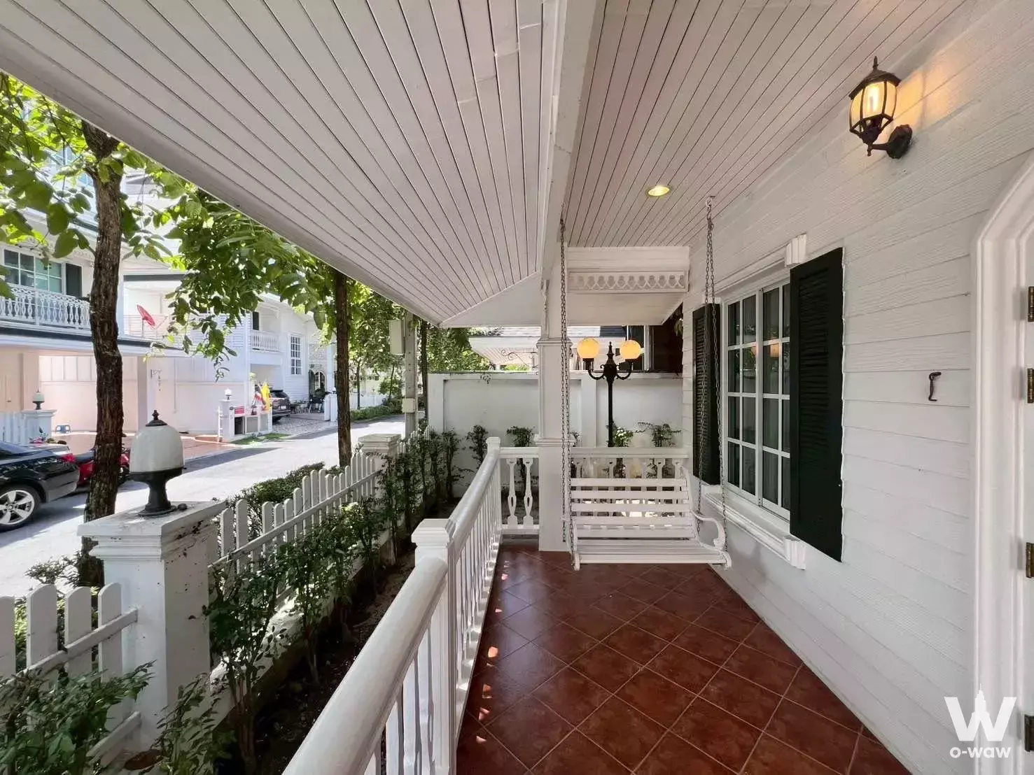 Covered porch of 4-bed house for sale in Fantasia Villa2 featuring white wood walls, ceramic tiles, and a hanging swing