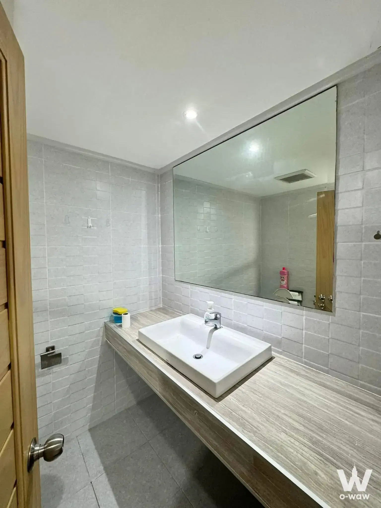 Modern bathroom with grey subway tiles and floating vanity in 2-bed Saranjai Mansion condo for rent