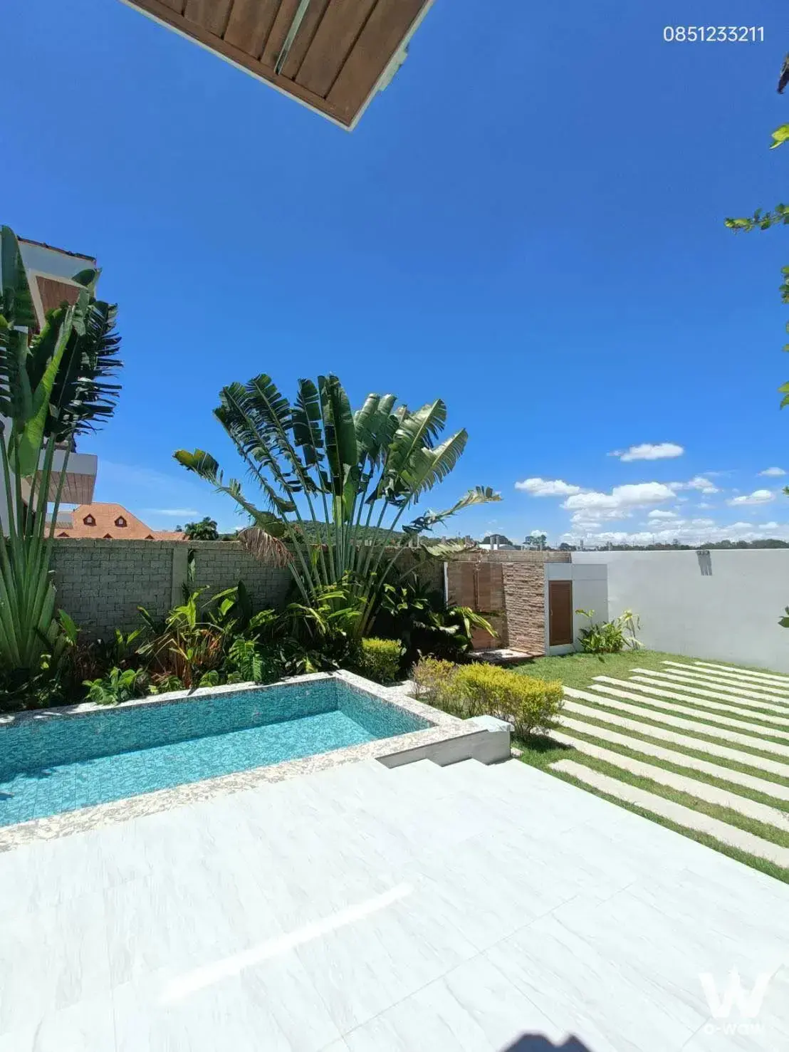 Modern outdoor patio with marble deck and mosaic pool at 5-bed house for sale in Atmos Prime Villa Pattaya