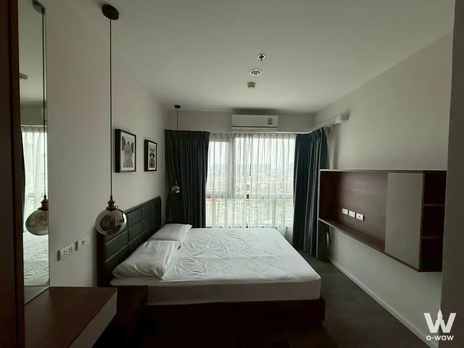 Queen bed bedroom in 1-bed for rent at The Stage Taopoon Interchange with dark wood floors and city views