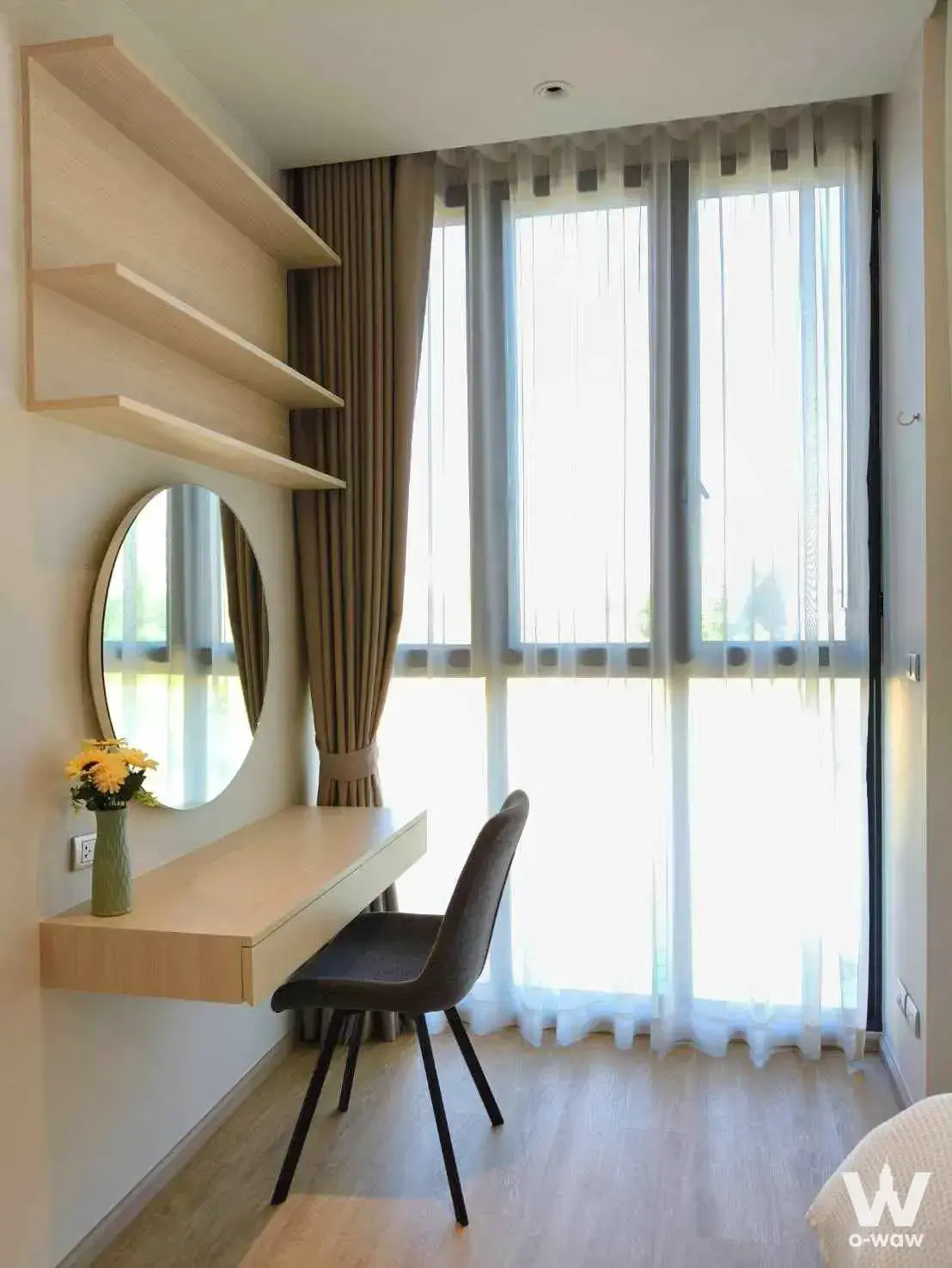 Study nook in Bearing Residence bedroom featuring light oak floating desk, shelves, and large window