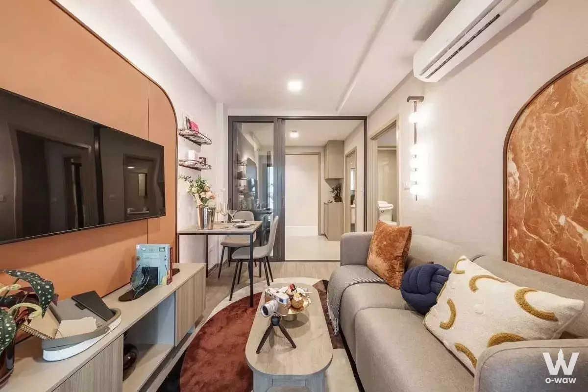 Modern living room in 1-bed condo for sale at The Base Ratchada 19 with terracotta accents and marble coffee table