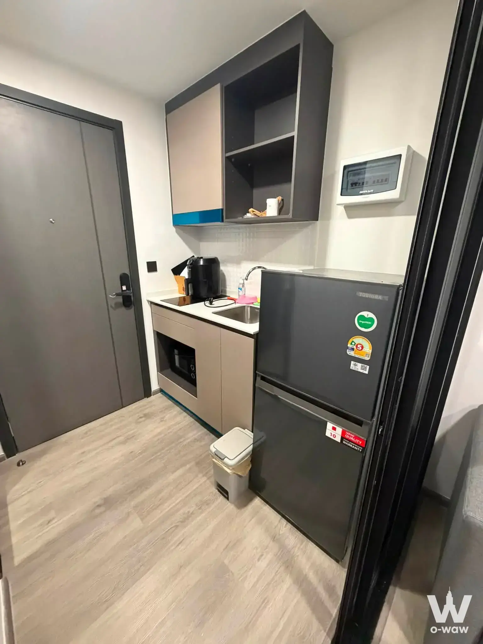 Minimalist kitchenette in an Atmoz Palacio rental with smart lock entry and fridge