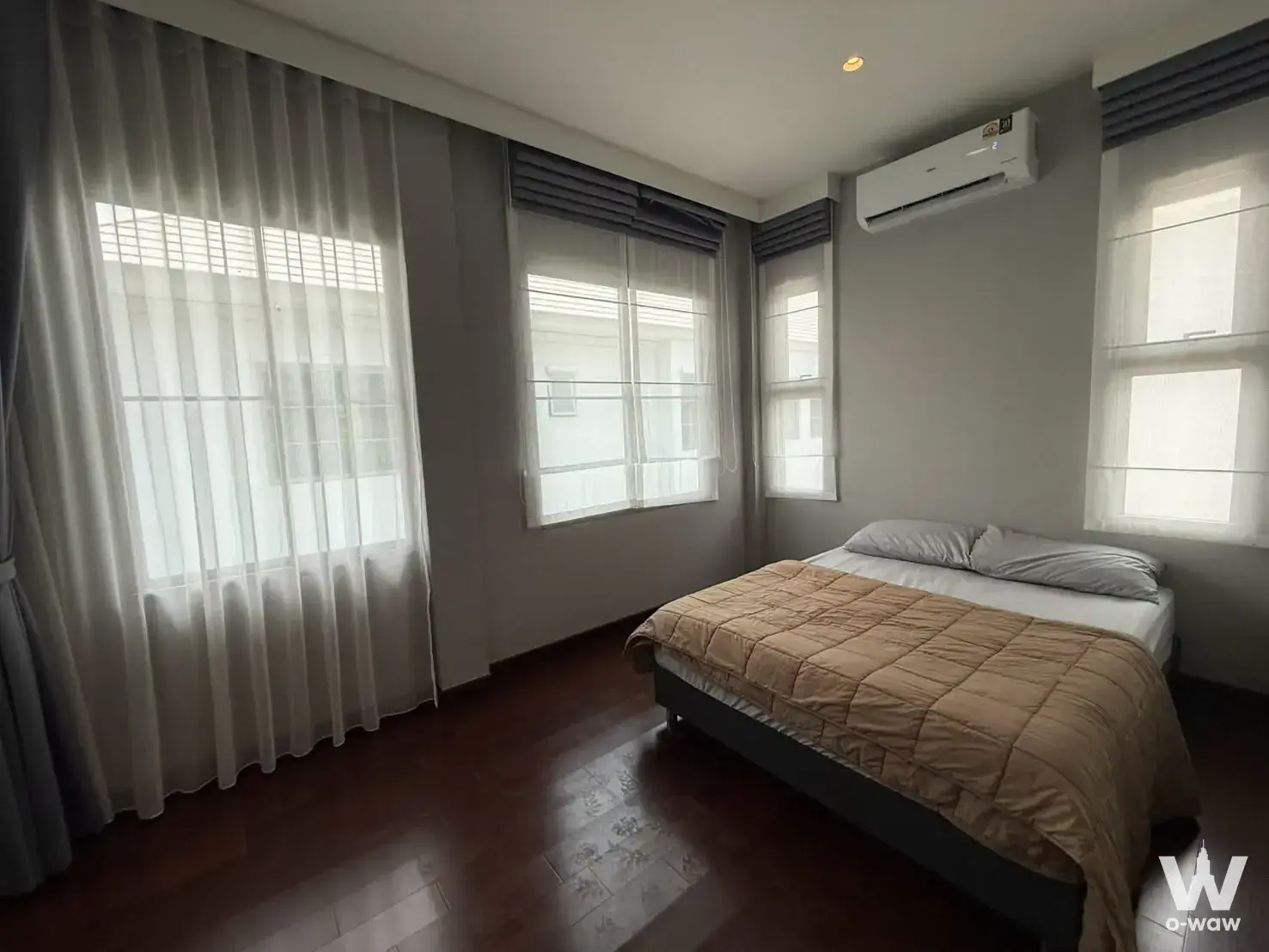 Minimalist bedroom in a 4-bed house for sale at Perfect Masterpiece Sukhumvit 77 with queen bed and sheer curtains