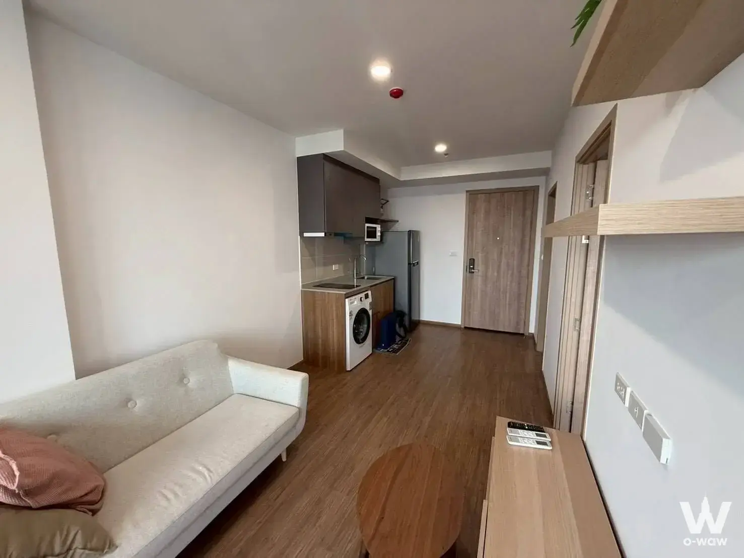 The LIVIN Phetkasem furnished 1-bed condo featuring open-plan living and modern kitchenette
