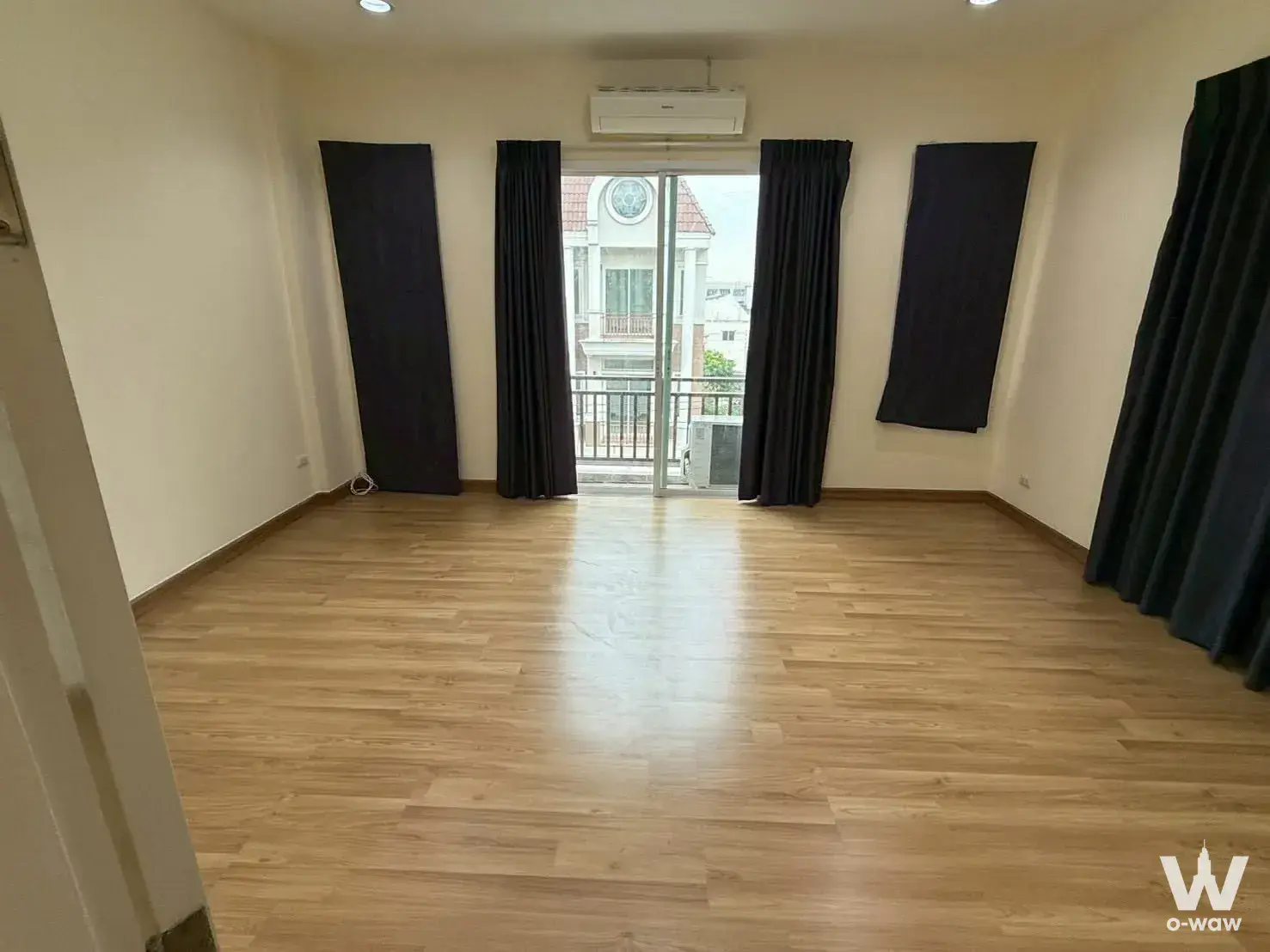 Spacious unfurnished room with oak floors, navy curtains, and balcony access in 5-bed townhouse for rent at Premium Place