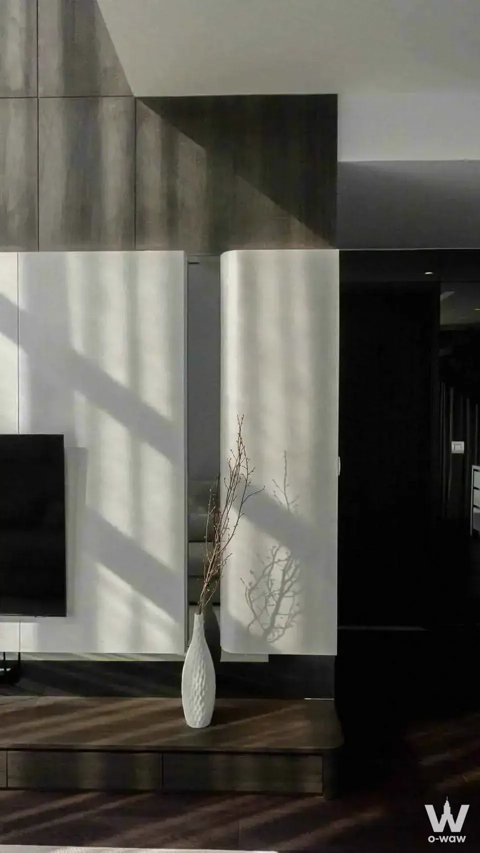 Modern living room in a 2-bed condo for rent in LAVIQ Sukhumvit 57 with built-in cabinetry and sunlight shadows