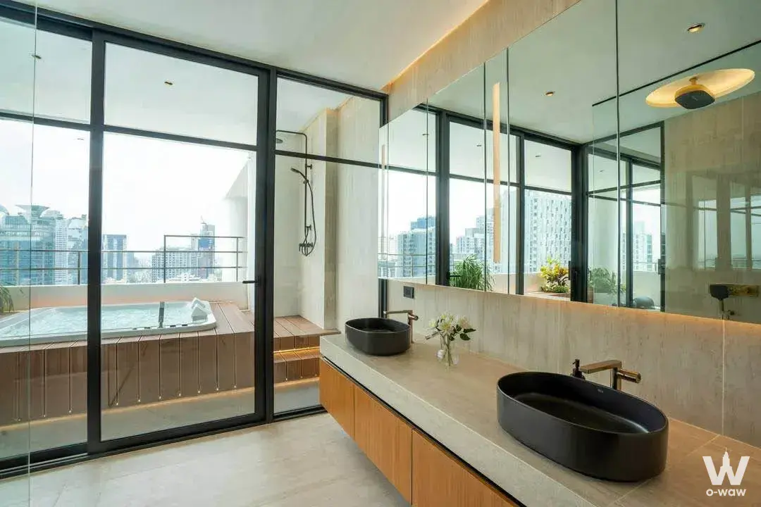Master bathroom in The Park Condominium with double sinks and glass doors to the terrace