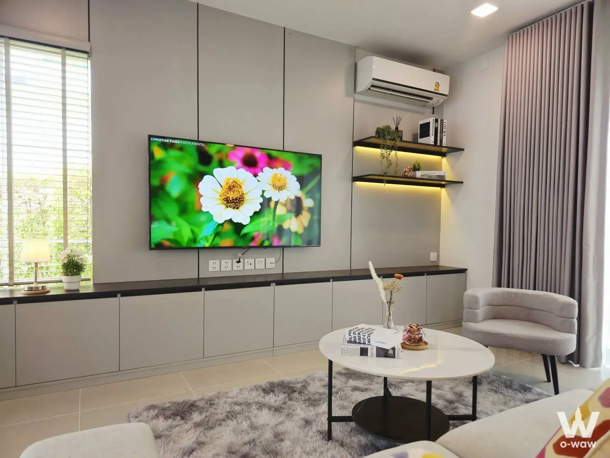 Modern living room with grey shag rug and built-in media unit in 3-bed house for rent Chaiyapruek Bangna KM15