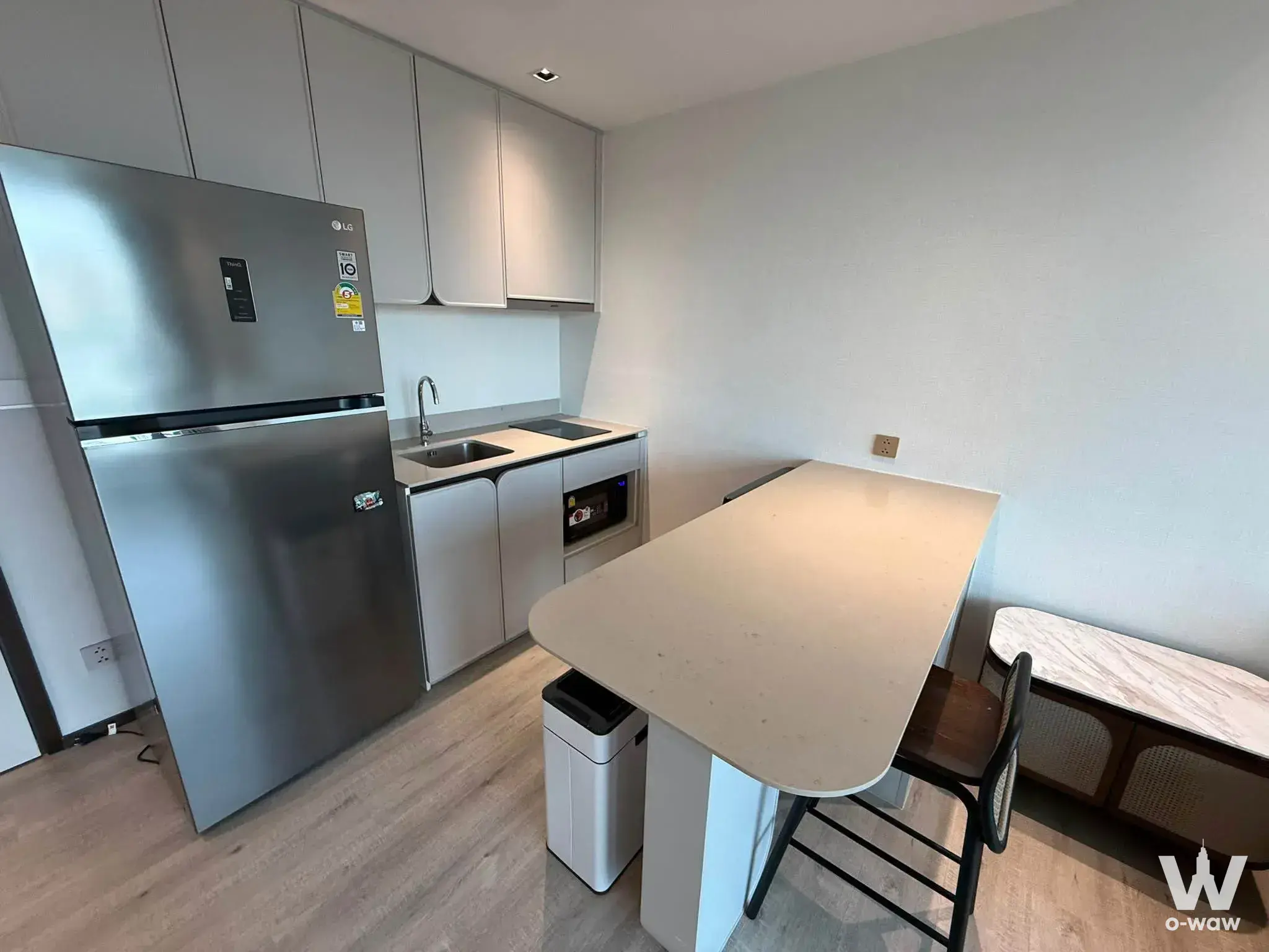 Modern kitchen and dining area in 1-bed condo for rent at InterContinental Residences Hua Hin with matte grey cabinets and