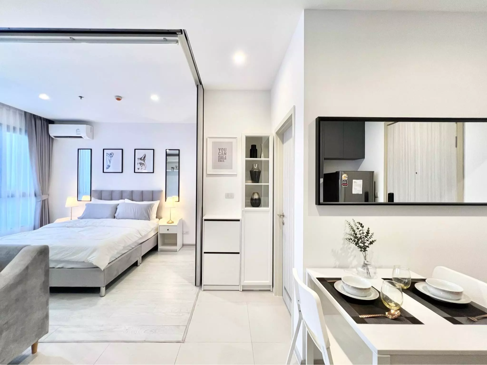 Modern 1-bed condo for rent in Grow Rattanthibet featuring glossy floors, dining area, and queen bed