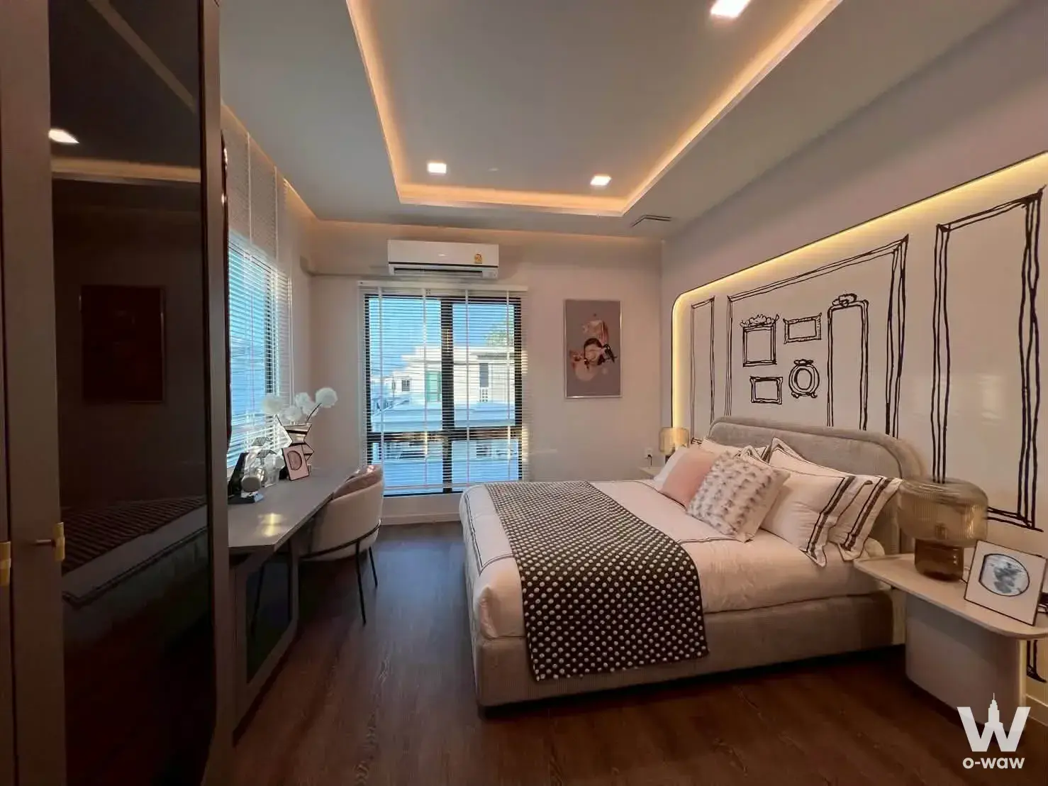 Mantana Bangna master bedroom featuring a queen bed, black line-art headboard, and warm lighting