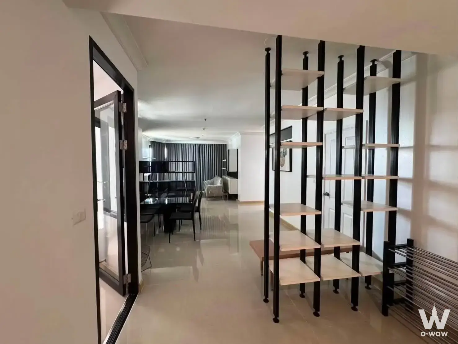 Modern living dining area in Supalai Casa Riva Vista 1 condo with glossy beige floors and industrial shelving divider