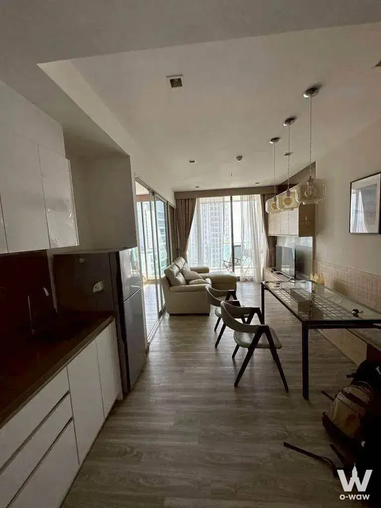 Modern 1-bed condo for rent in Baan Plai Haad Pattaya with open-plan living, kitchenette, and balcony city views
