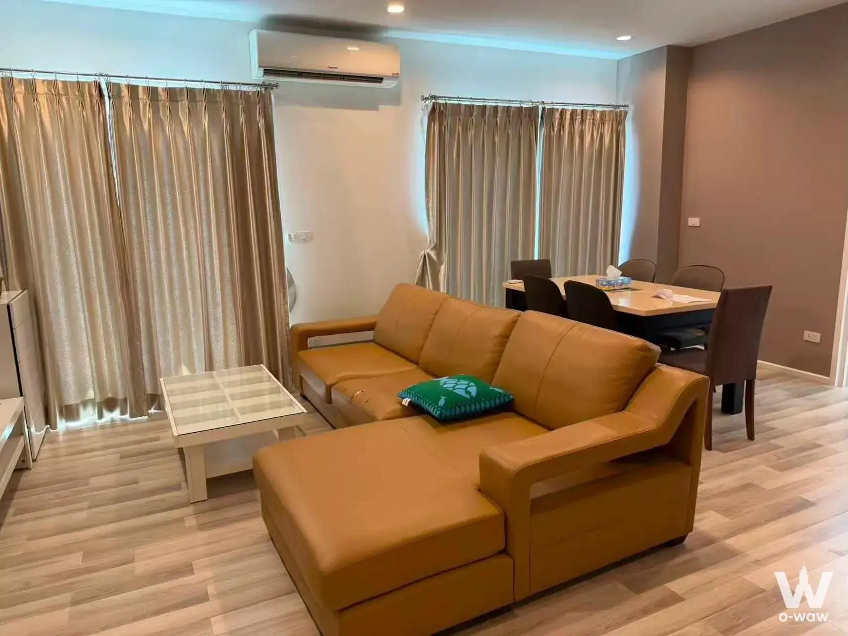 Open-plan living and dining area with sectional sofa in The Key BTS Wutthakat