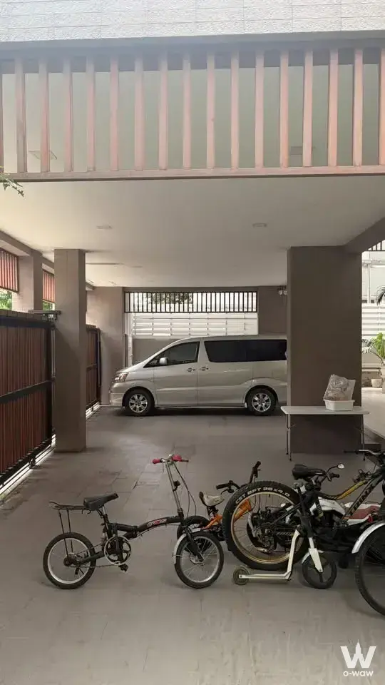 Covered carport in Nantawan Srinagarindra with silver van, bicycles, and metal gate