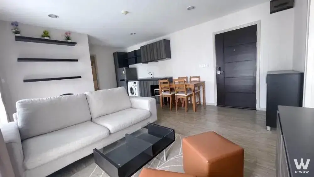 Modern 2-bed condo living room in Villa Lasalle with white sofa and orange accents