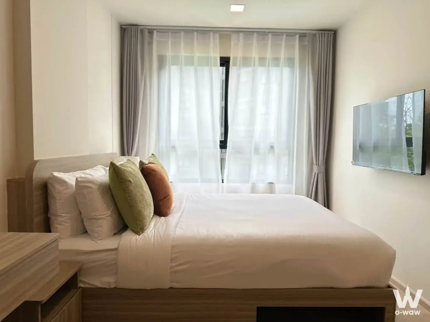 Bedroom with queen bed and greenery view in The Base Cherngtalay 1-bed condo for rent
