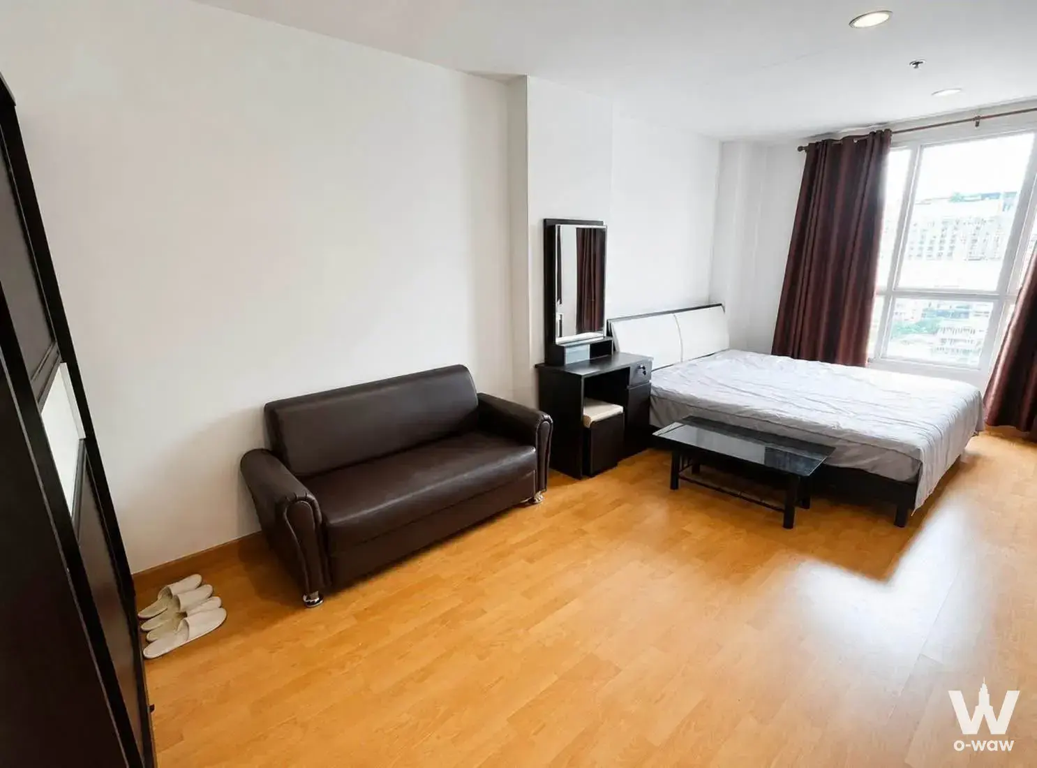 Fully furnished studio bedroom at Life Ladprao with leather sofa and city view window