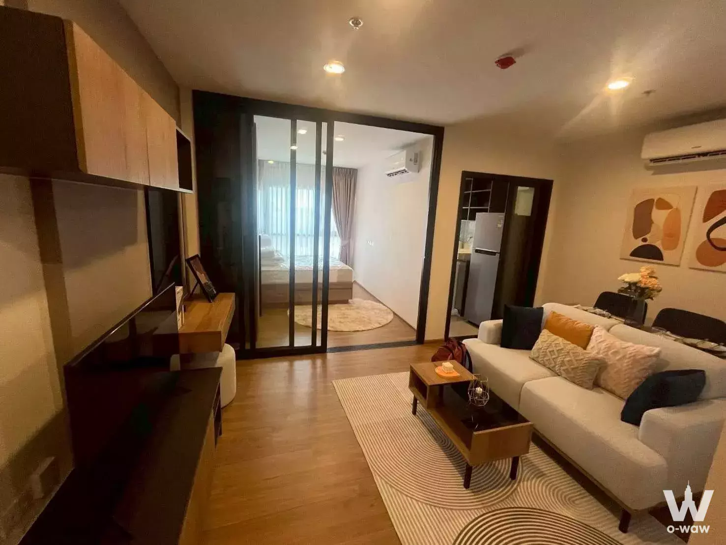 Modern 1-bed condo for rent in The Line Vibe with wood floors, white sofa, and open-plan living space