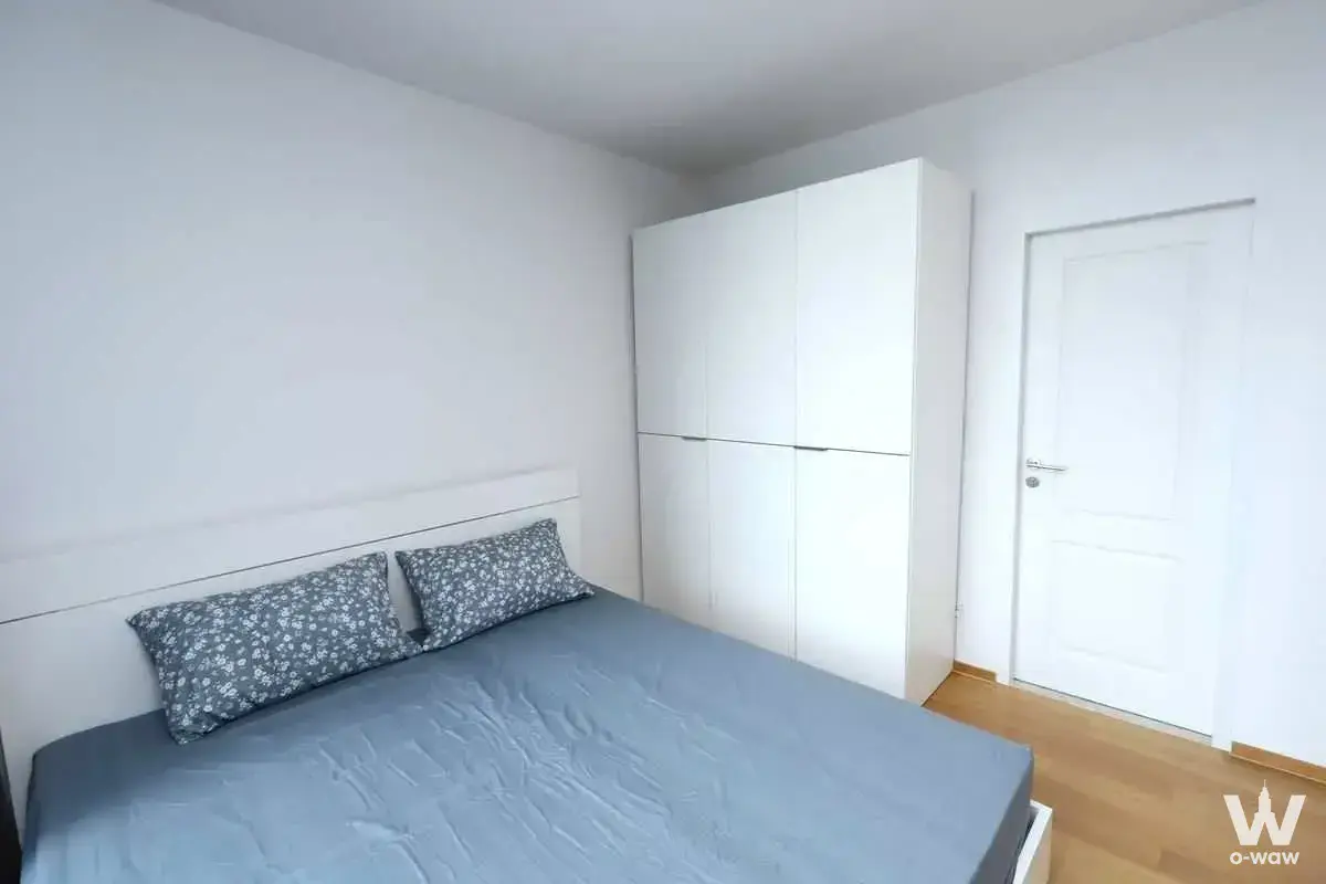 Minimalist bedroom in a 1-bed condo for rent at Noble Revo Silom has a double bed and a tall white wardrobe