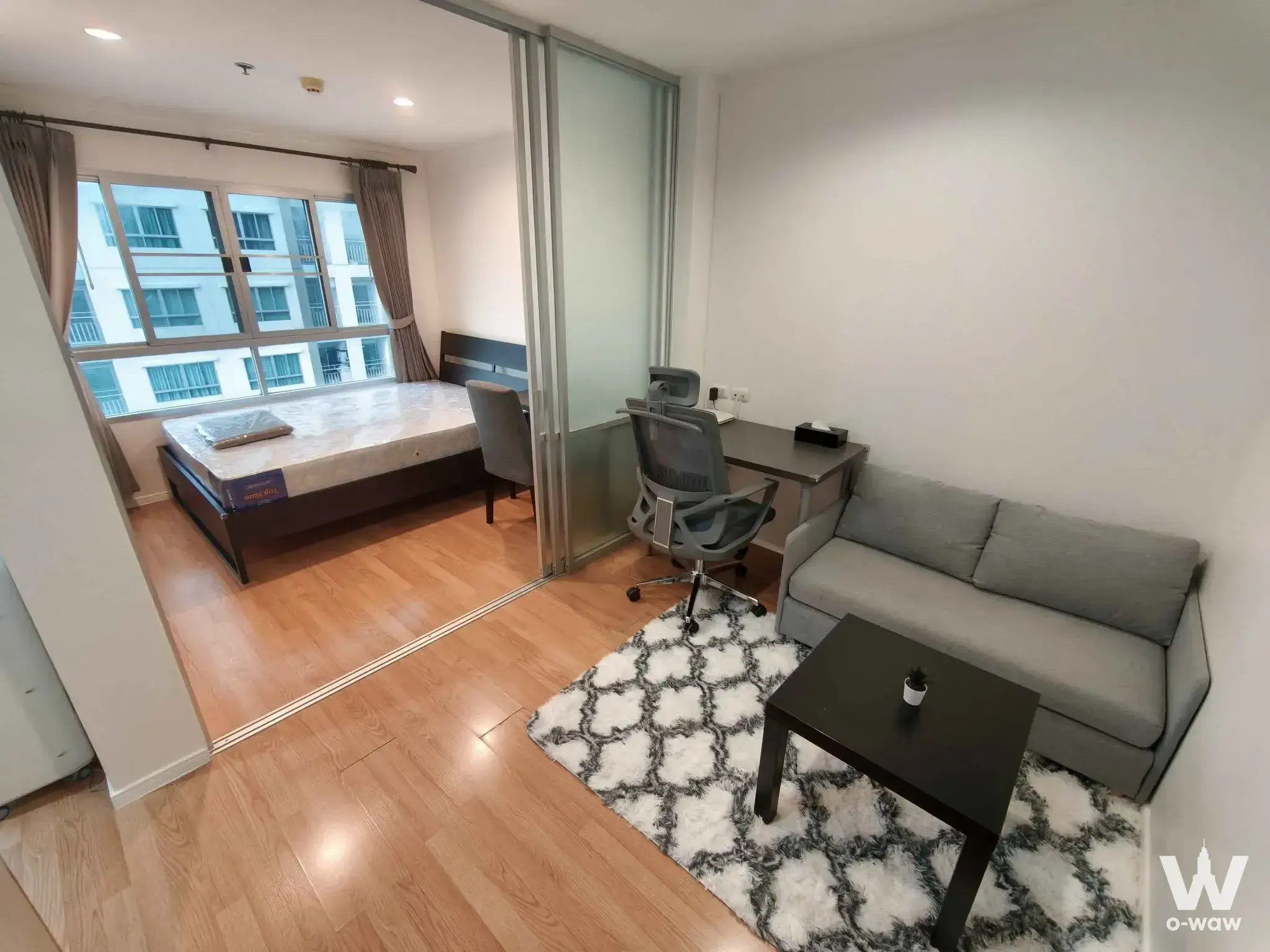 Lumpini Mega City Bang Na studio with glass-partitioned office nook and platform bed