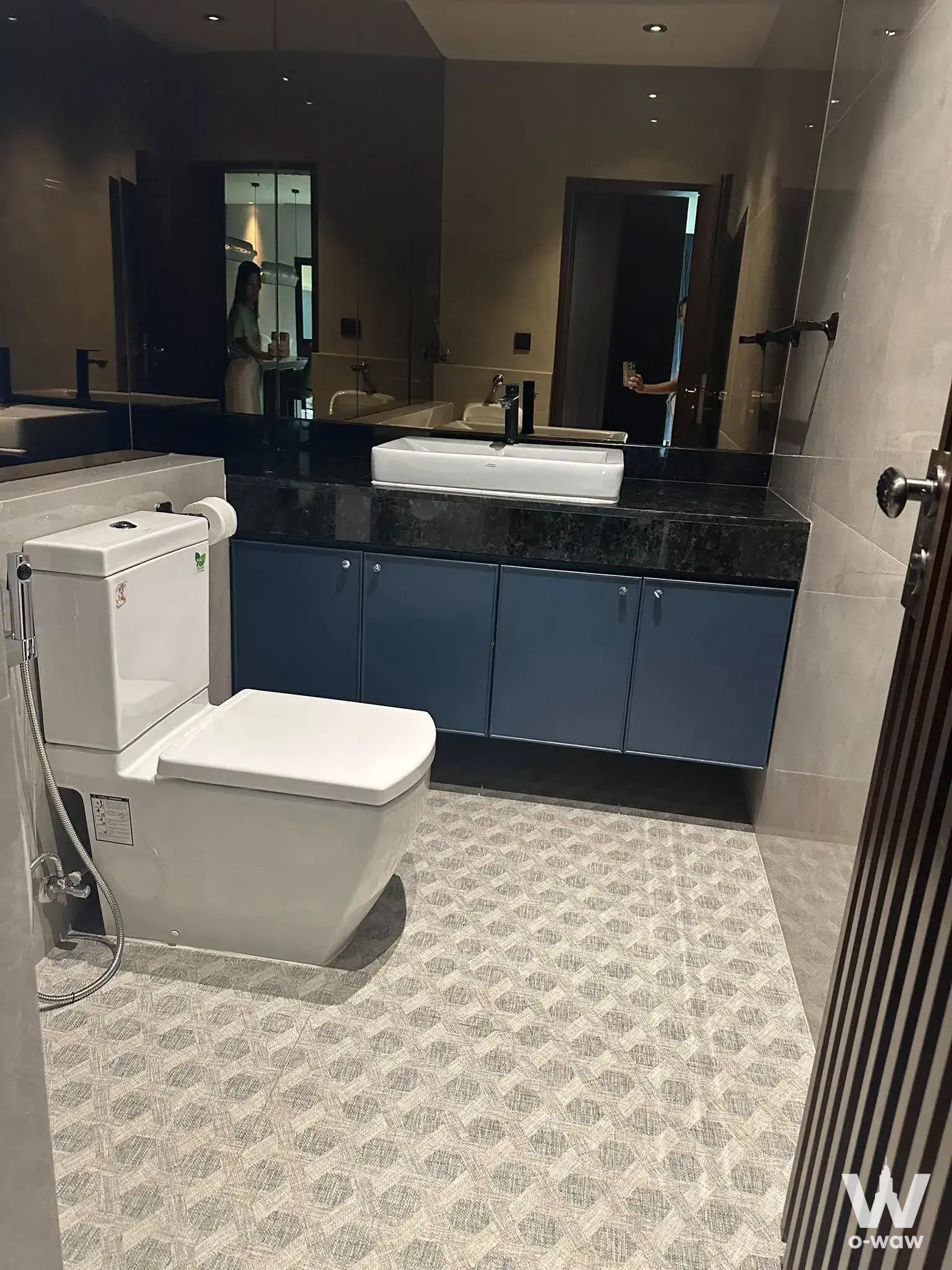 Modern bathroom in 3-bed house for rent at Perfect Place Krungthep Kreetha with dark blue vanity and vessel sink