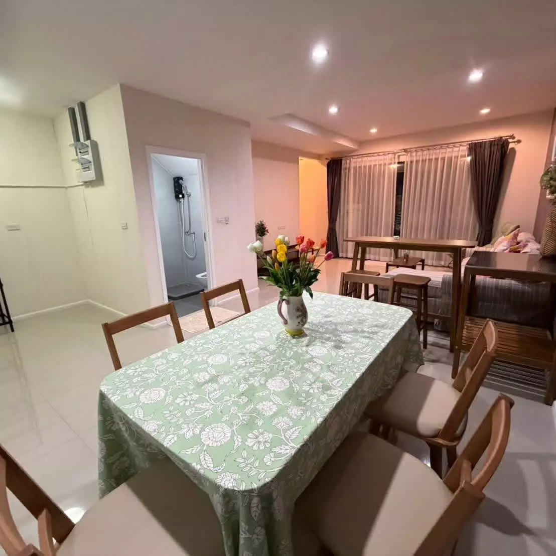 Furnished dining and living area in 2-bed townhouse for rent at Plex Residence Kaset - Nawamin featuring wooden furniture
