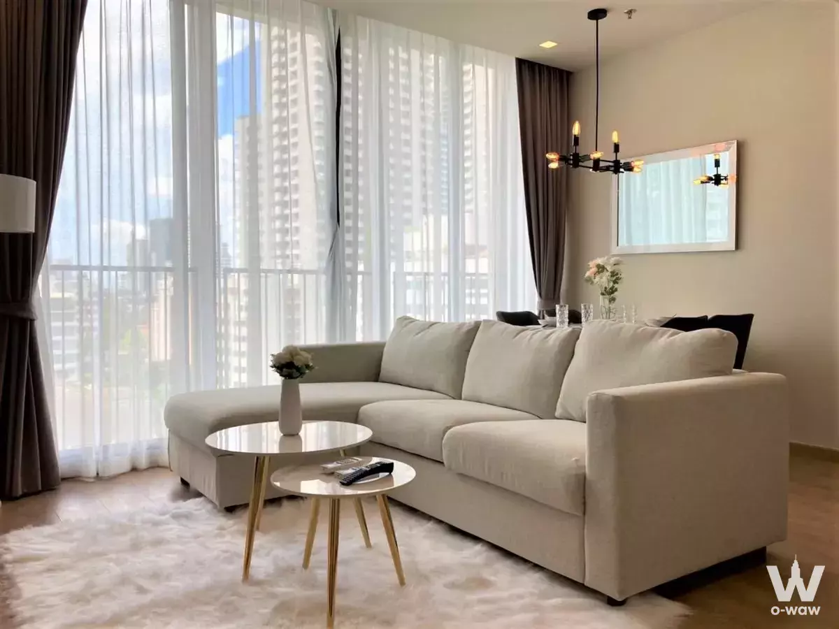 Modern living room in 2-bed condo for rent at Noble Around Sukhumvit 33 with floor-to-ceiling windows and city views