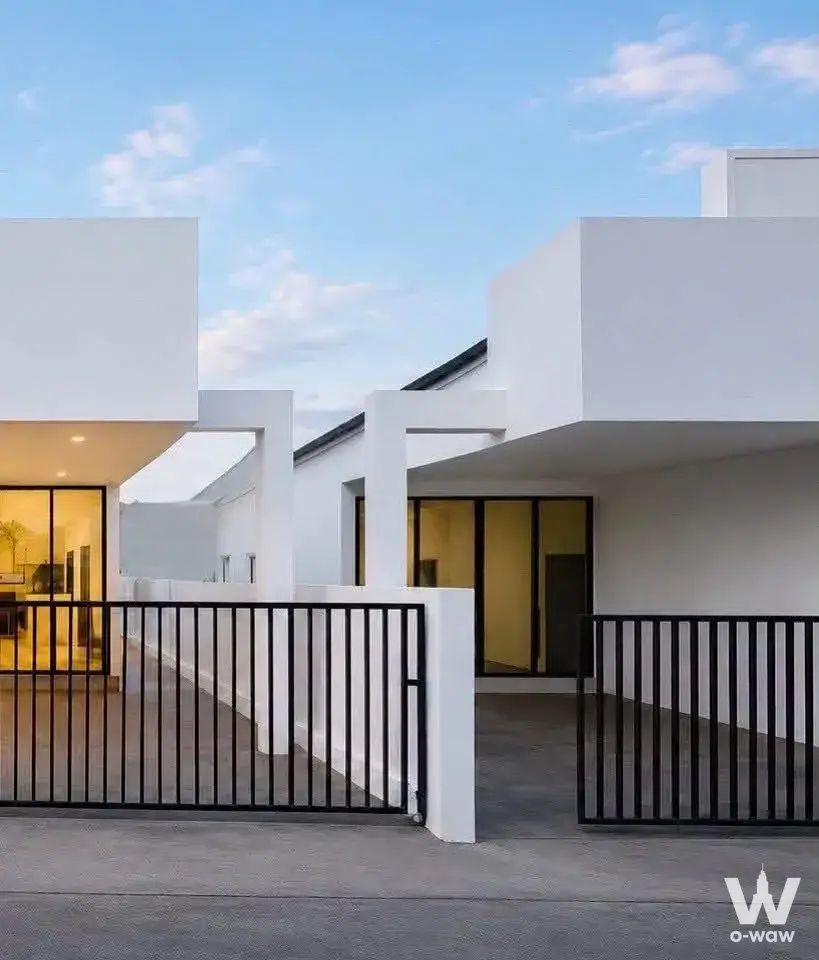 Modern white villa exterior with black gate and glass windows for rent in Siam Country Club Bangkok