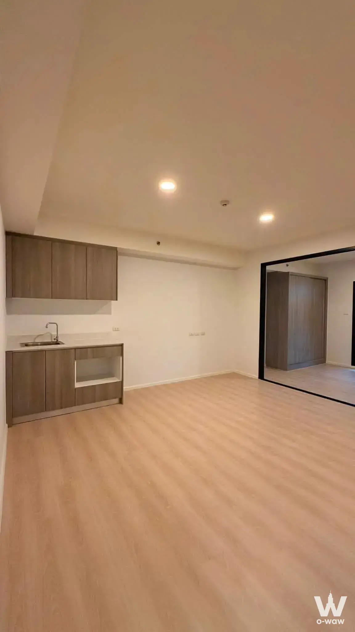 Unfurnished kitchenette in a 1-bed condo for sale at A Space Condominium featuring light oak laminate flooring