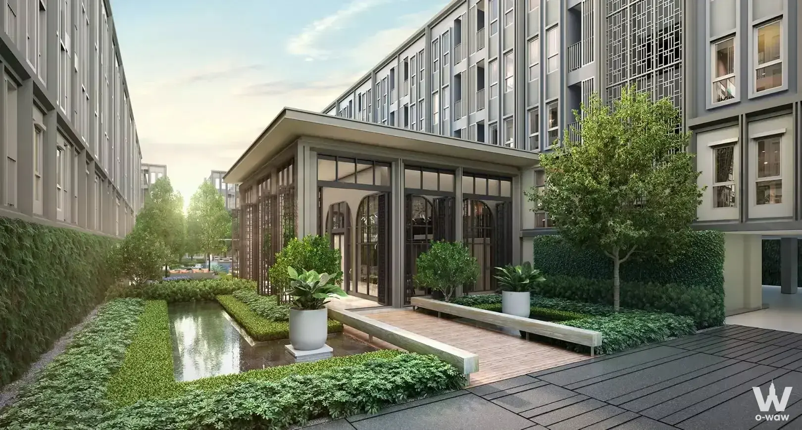 The courtyard of a 1-bed condo for rent at Aspire Pinklao has a glass pavilion and water channel
