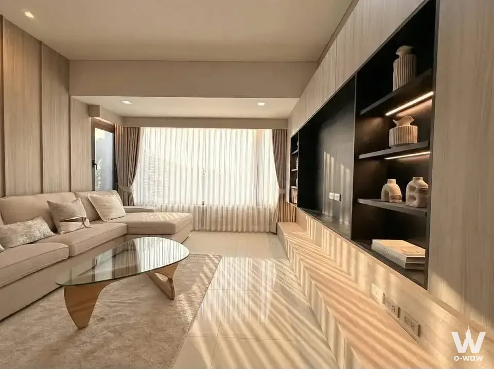 Luxury condo living room featuring beige sectional, marble floors, and LED media wall