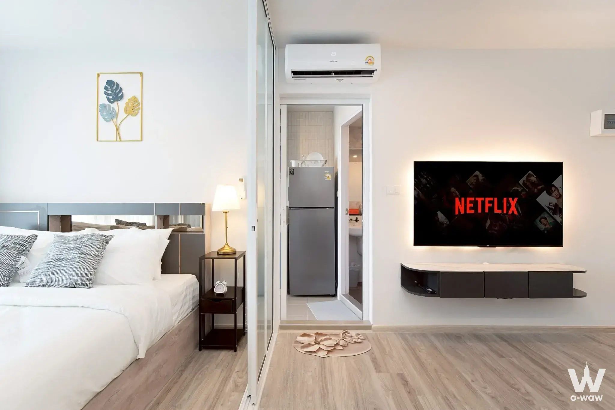 Studio bedroom in Regent Home Bangna featuring mirrored headboard and Netflix setup