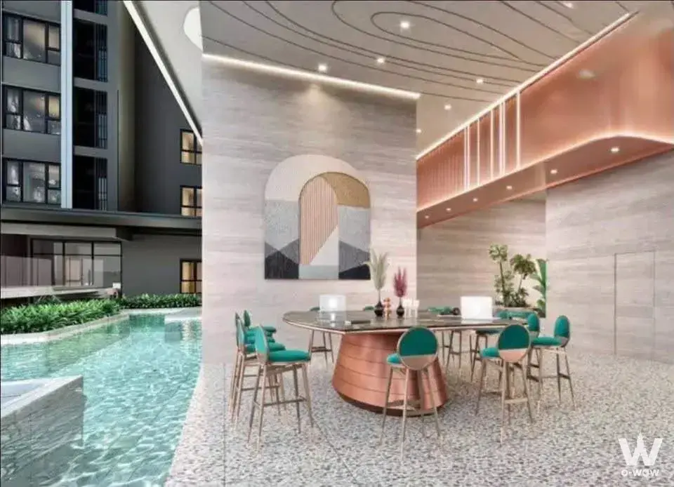 Aspire Sukhumvit-Rama 4 poolside lounge with infinity pool, teal velvet bar stools, and copper accents