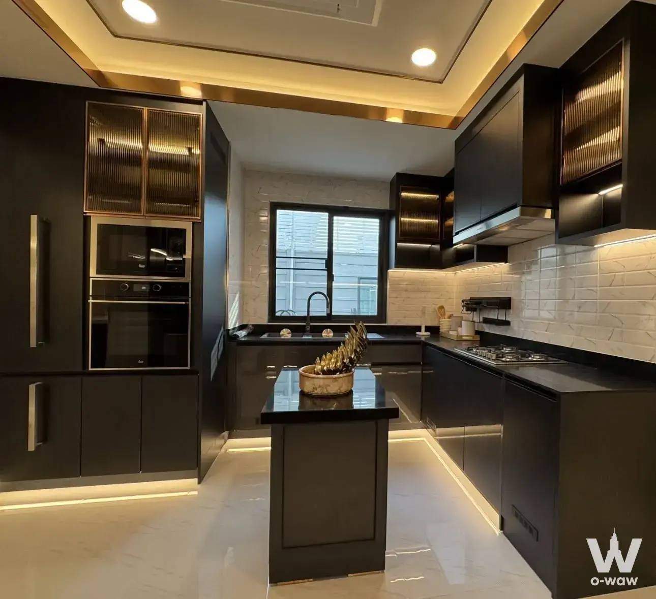 Modern kitchen in 5-bed condo for rent at The City Sukhumvit-Onnut 2 with black cabinets and gold accents