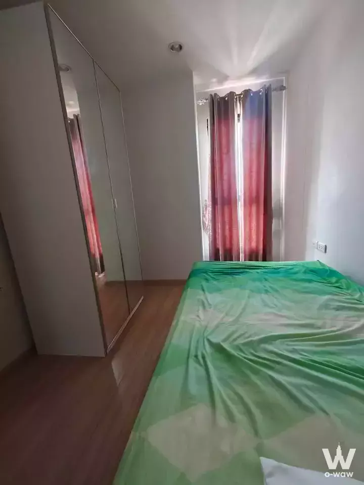 Modern bedroom with wood floors, mirrored wardrobe, and blue-to-red gradient curtains in 2-bed condo for sale at THE BASE