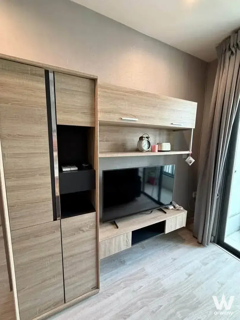 Living room with floor-to-ceiling light wood storage unit in IDEO Mobi Tower B