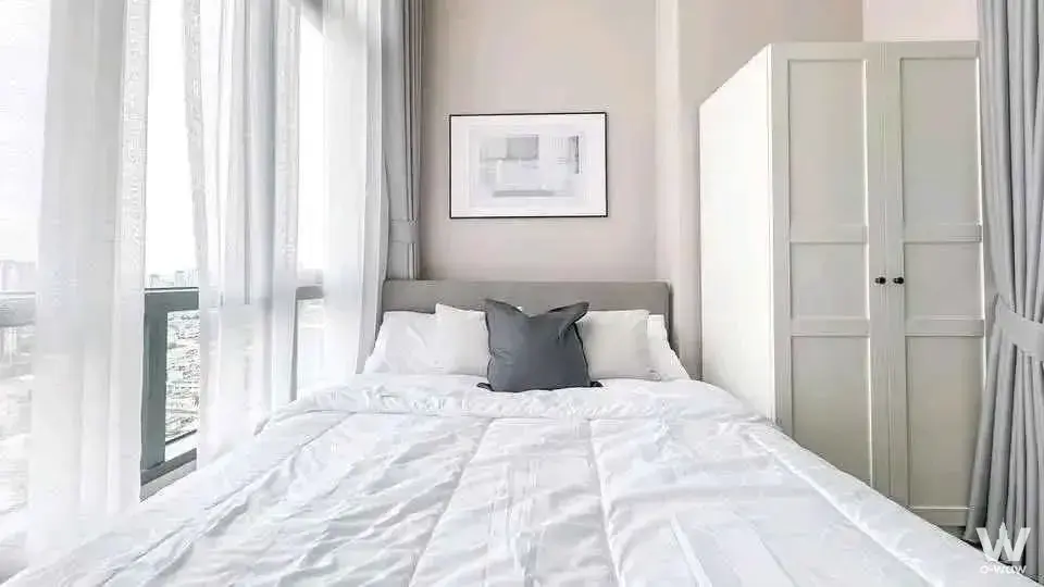 Modern bedroom with floor-to-ceiling windows and city view in 2-bed condo for rent at Metro Sky Prachachuen