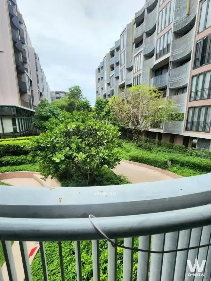 Balcony view of landscaped courtyard garden at Kawa Haus 1-bed condo for rent in Bangkok