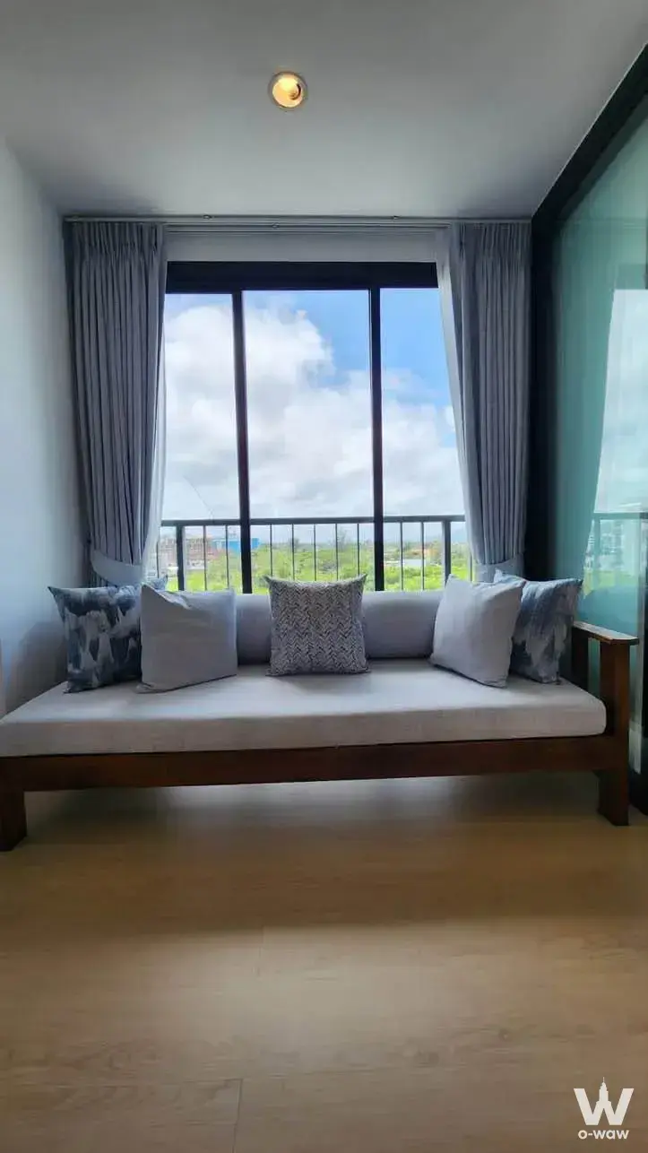 Living nook with teal glass panel and daybed view in Zcape 2 condominium