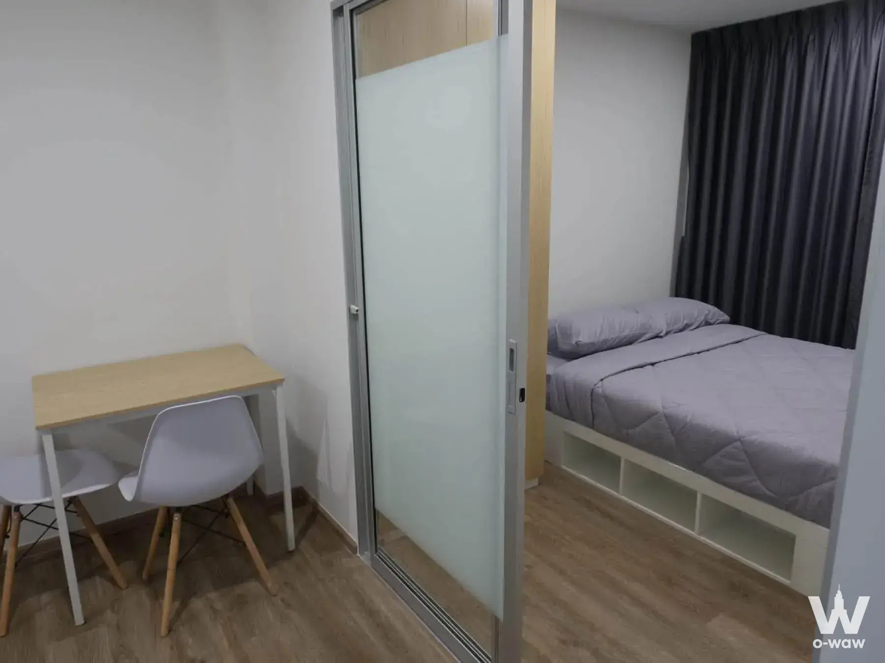 Modern 1-bed condo bedroom in Sena Kith Srinakarin-Sridan with desk, wardrobe divider, and twin bed