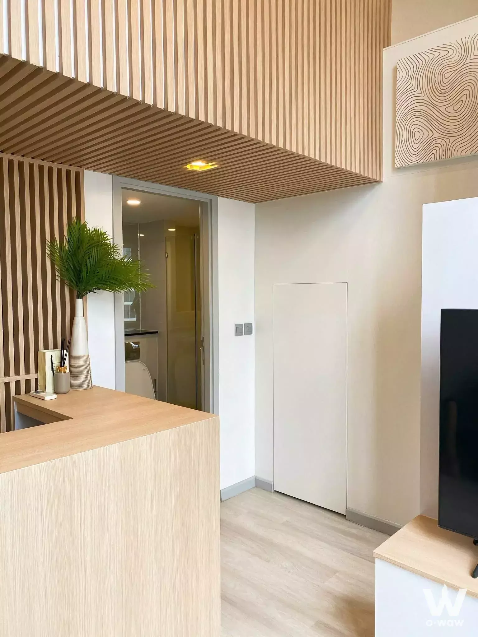 Living area with oak slat ceiling and partition in KnightsBridge Prime Sathon 1-bed condo for sale