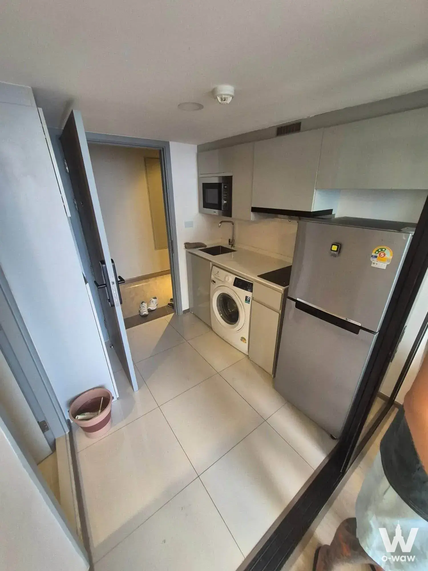 1-bed condo for rent in SOHO Bangkok Ratchada showing a compact kitchenette with stainless steel appliances