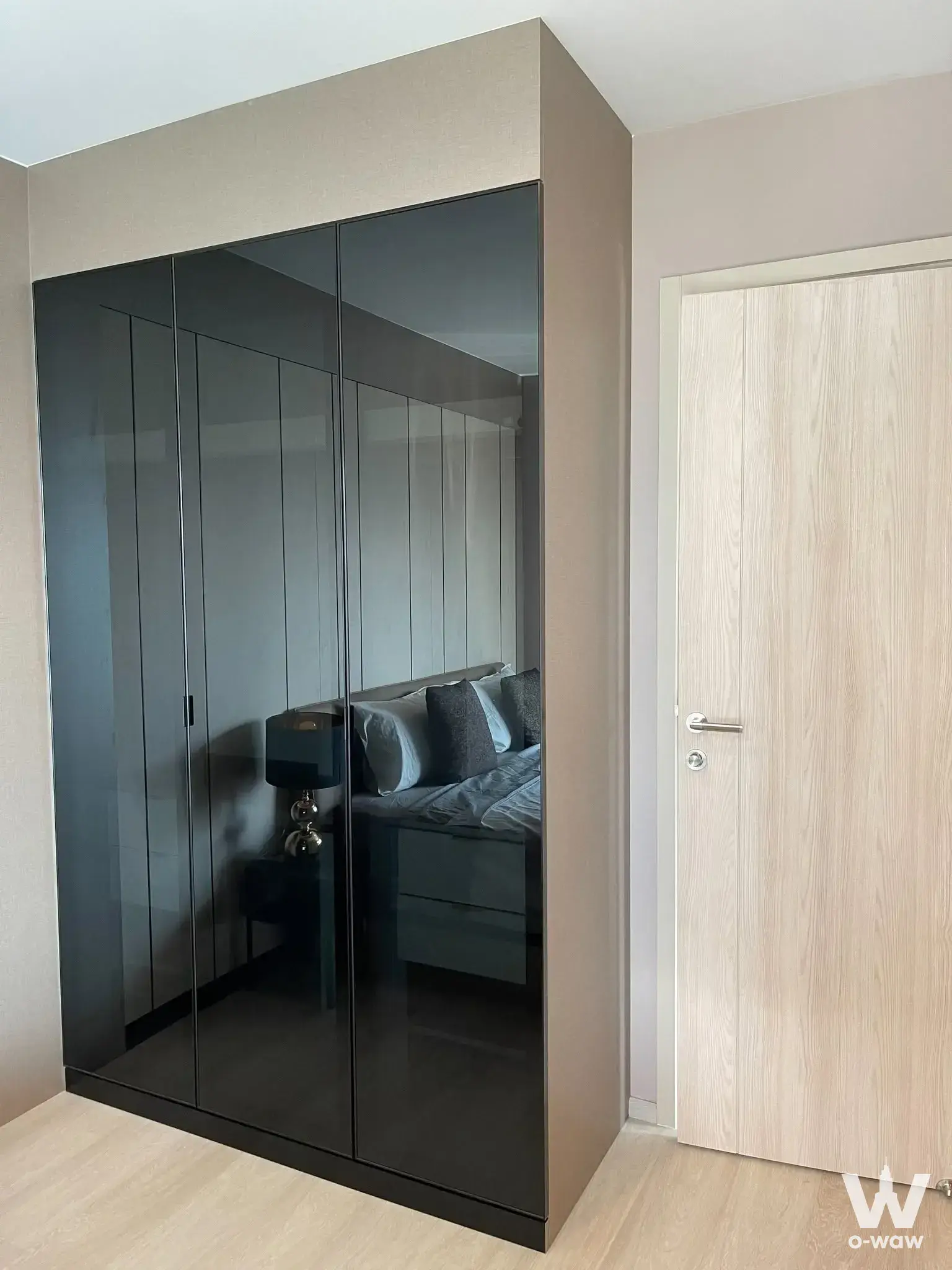 Bedroom featuring a floor-to-ceiling mirrored wardrobe and grey bedding in Life One Wireless condo