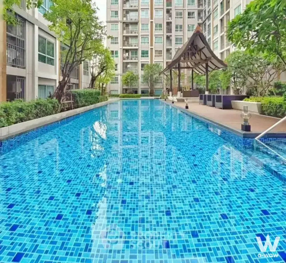 DBura Prannok 1-bed outdoor pool with blue mosaic tiles, wooden deck, Thai-style pavilion, and tropical landscaping