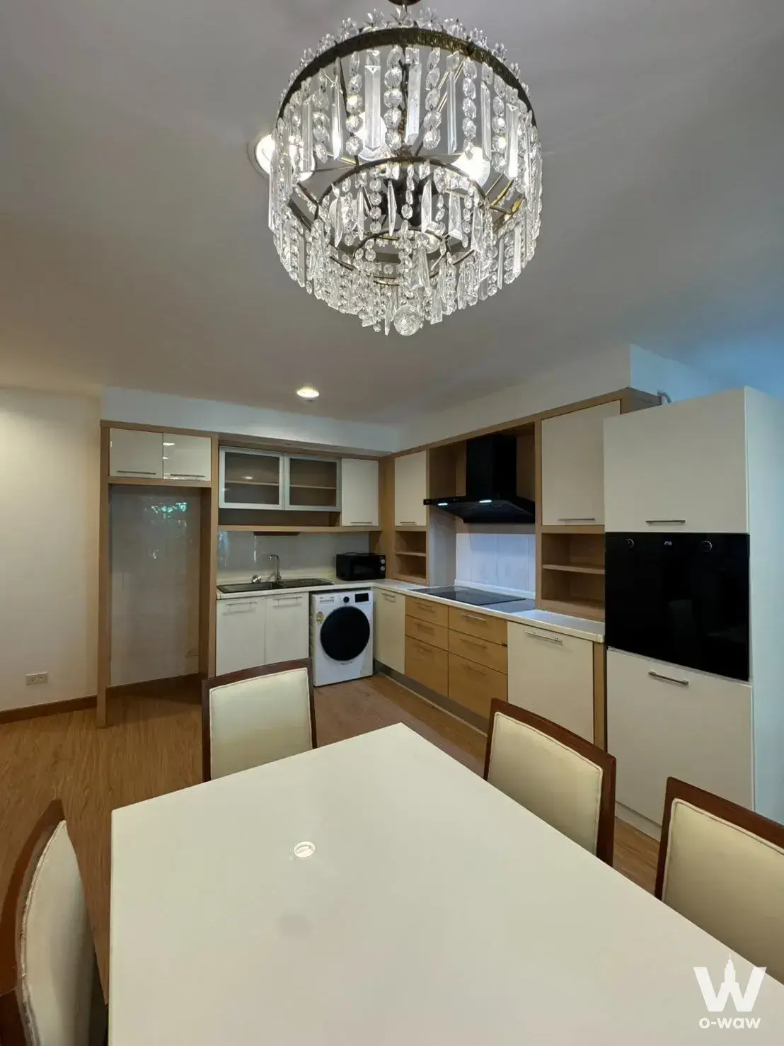 Open-plan kitchen with crystal chandelier in a 2-bed condo for sale in The Bangkok Narathiwat