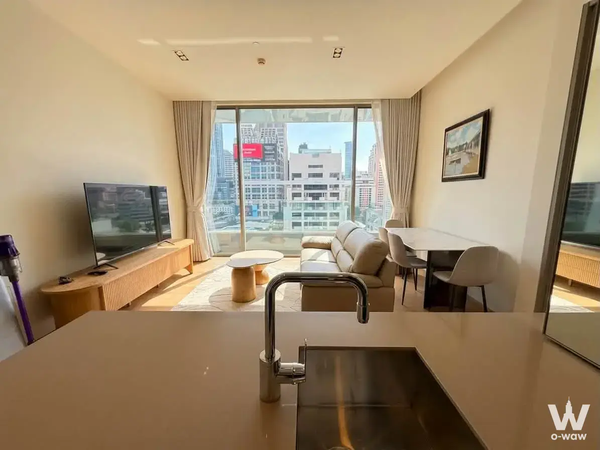 Open-plan kitchen with quartz island and city views in this furnished 1-bed condo for rent at SALADAENG One