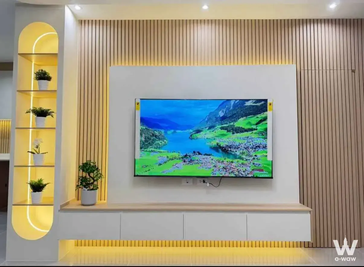 Living room with slat wall entertainment unit and arched niche in Pleno Sukhumvit-Bangna 2 3-bed house